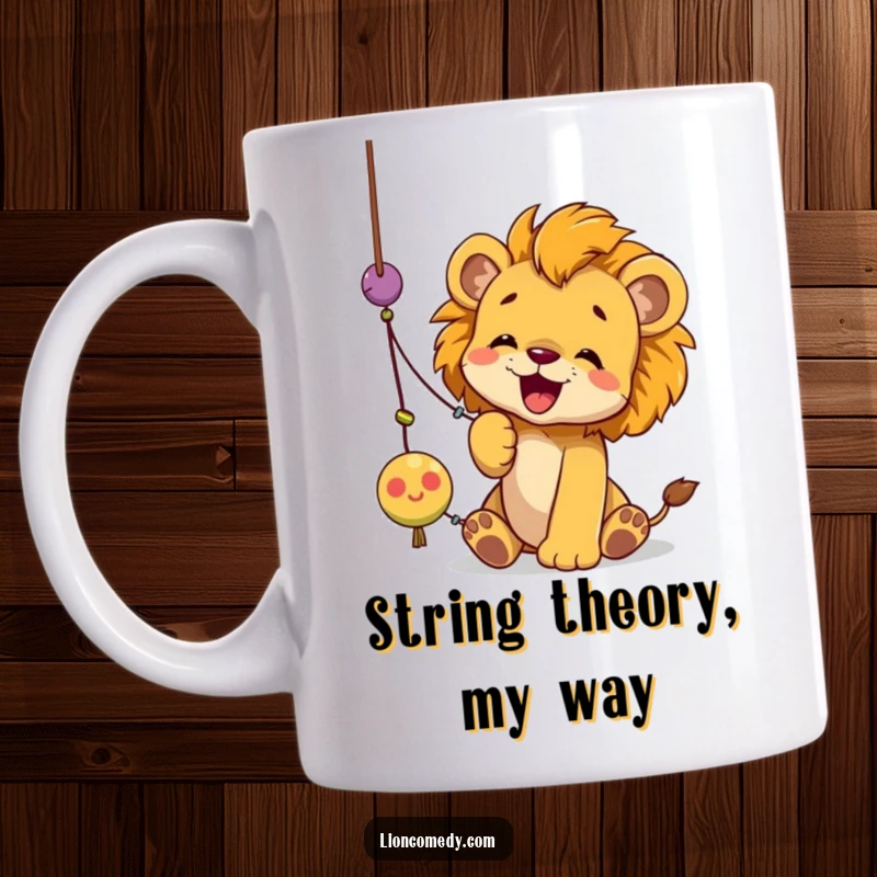 Funny lion cub mug showing a playful cub gleefully batting at a dangling string toy with its paws.