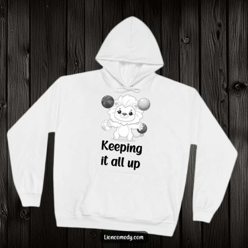 Funny kawaii lion hoodie featuring a cute, determined lion focused on expertly juggling three colorful balls.