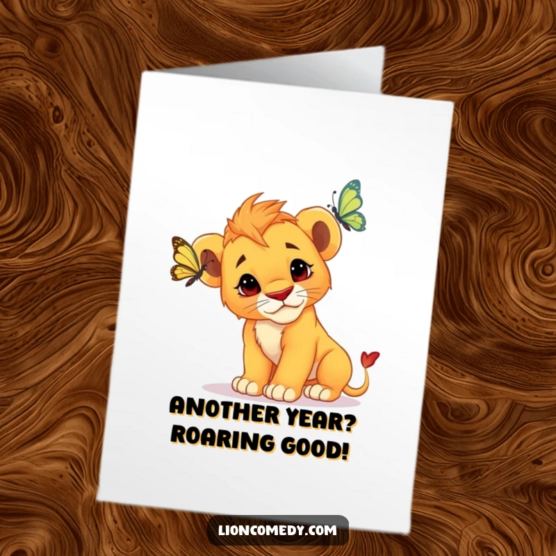 Funny Free Printable birthday card featuring a curious lion cub tilting its head, observing a butterfly with wide eyes.