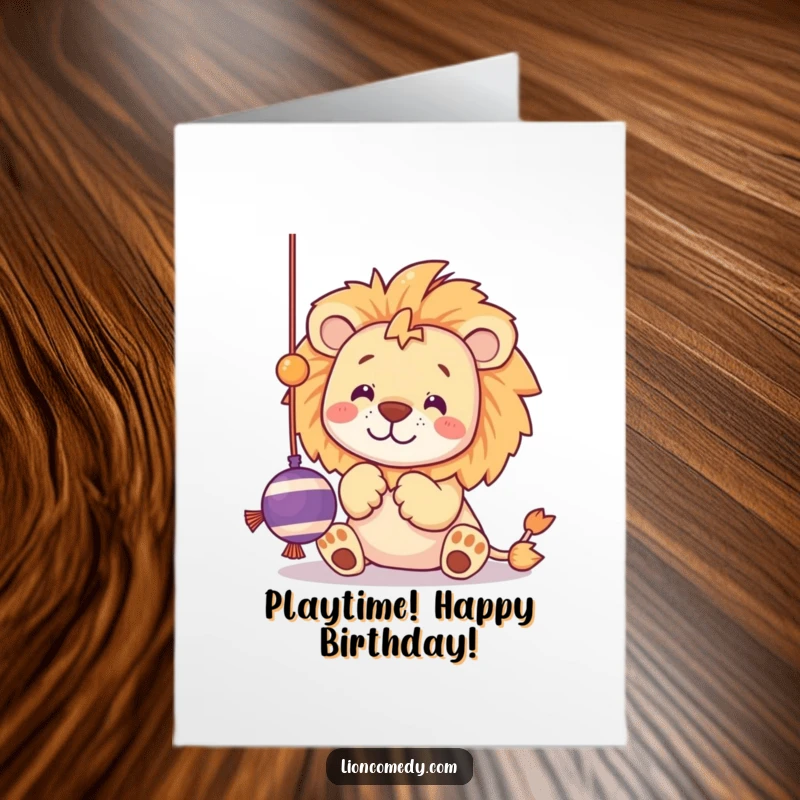Funny Free Printable Birthday Card showing a kawaii lion playfully batting at a dangling string toy with its paws, ready for fun.